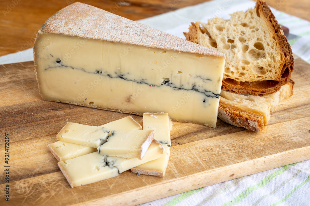 Cheese collection, French Morbier semi-soft cow milk cheese with black mold layer close up Cheese collection, French Morbier semi-soft cow milk cheese with black mold layer close up