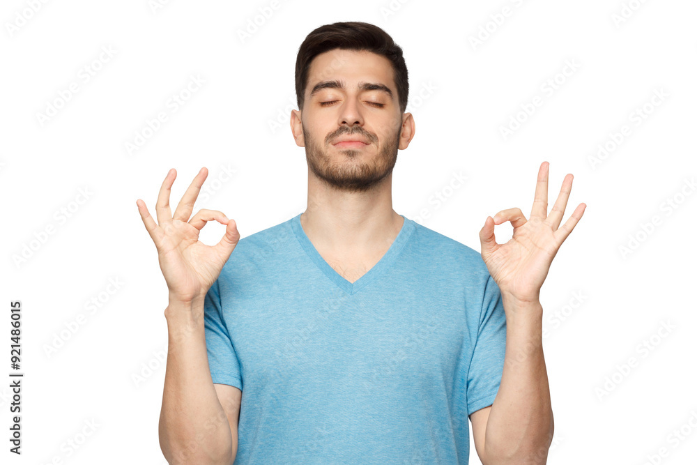 Concentrated relaxed man standing with closed eyes, having relaxation while meditating, trying to find balance and harmony. Yoga and meditation concept Concentrated relaxed man standing with closed eyes, having relaxation while meditating, trying to find balance and harmony. Yoga and meditation concept