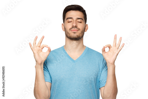 Vászonkép Concentrated relaxed man standing with closed eyes, having relaxation while meditating, trying to find balance and harmony