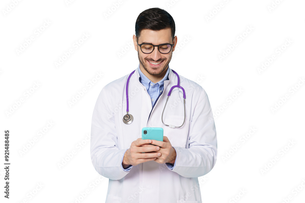 Young doctor in white coat smiling, holding his phone with both hands, using medical app Young doctor in white coat smiling, holding his phone with both hands, using medical app