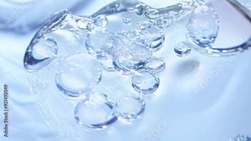 Wallpaper Mural A single droplet of water hovers gracefully above a soft, textured surface, reflecting light and creating ripples. Torontodigital.ca