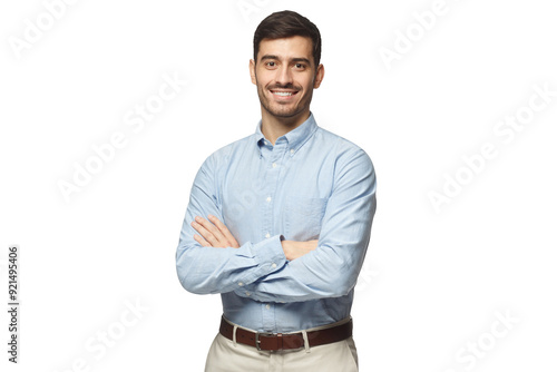 Handsome smiling businessman in blue shirt standing with arms crossed