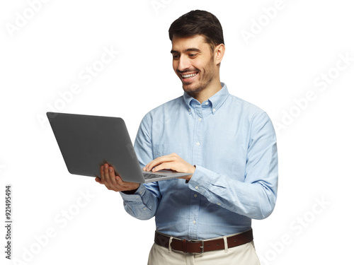 Young businessman using laptop, laughing, standing and smiling