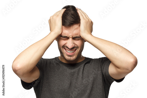 Headache concept. Young man squeezing head with hands. People, stress, tension and migraine concept