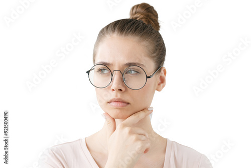 Thoughtful woman with hand on chin, looking away with a contemplative, focused expression