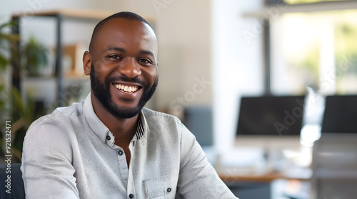 Smiling Man in Office: Smiling man sitting in an office.