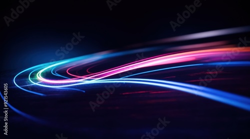 Dynamic neon glow twists and turns on a shadowy canvas evoking a sense of energy 