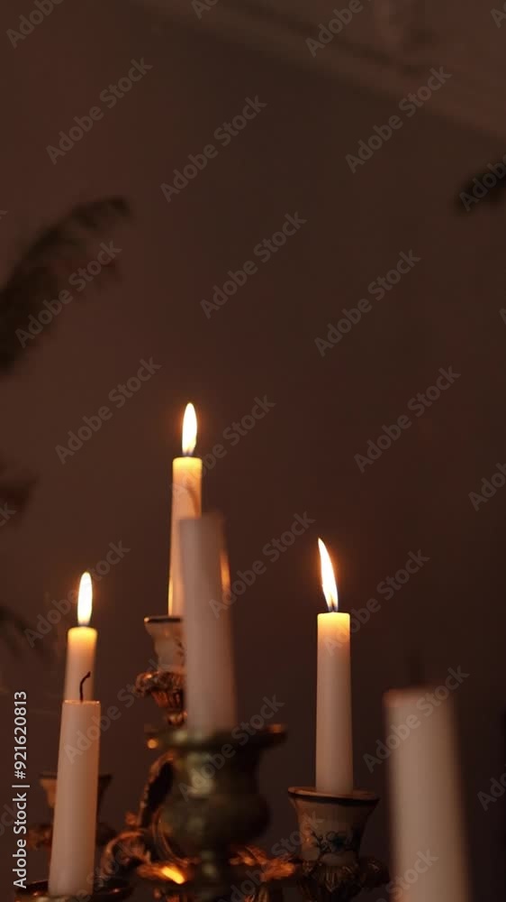 Burning candles blowing in the wind on a dark background. Candlestick close up. Fire, flame, smoke and candlelight, vertical video Burning candles blowing in the wind on a dark background. Candlestick close up. Fire, flame, smoke and candlelight, vertical video