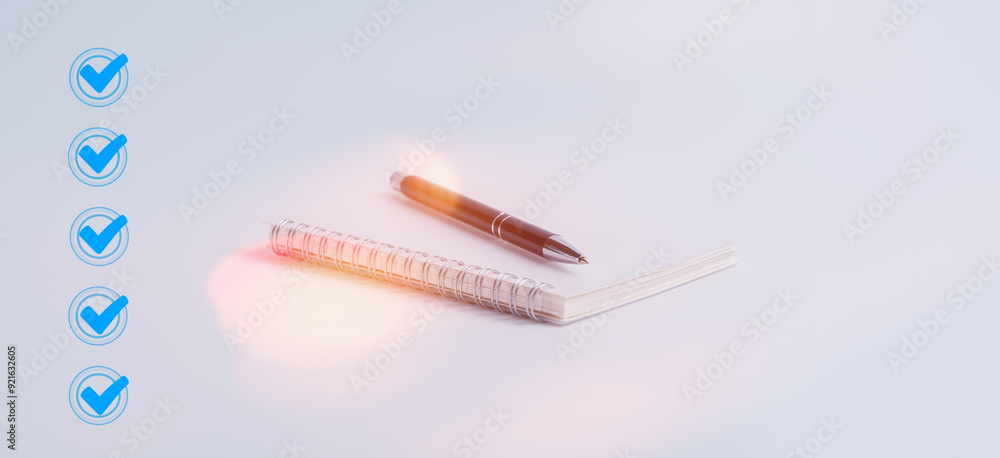 Close- up pen on check list notebook paper and virtual tick marks on ...
