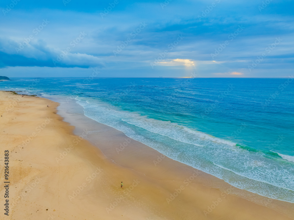Sunrise Seascape with beautiful cloud covered sky and gentle surf Sunrise Seascape with beautiful cloud covered sky and gentle surf