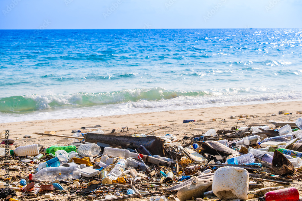 Trash, plastic cups and plastic bags at the beach. environmental problem concept and healing the world Trash, plastic cups and plastic bags at the beach. environmental problem concept and healing the world
