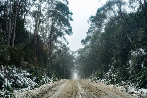 Road through snowy mountains photo