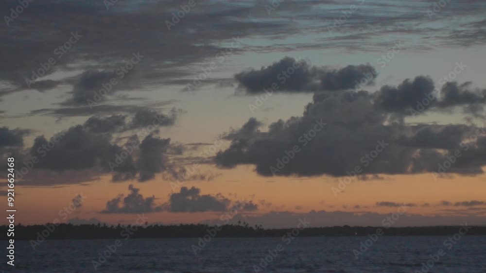 Magnificent sunset with a sky fading from orange to blue, sea meeting river, Bahia, Brazil. Magnificent sunset with a sky fading from orange to blue, sea meeting river, Bahia, Brazil.
