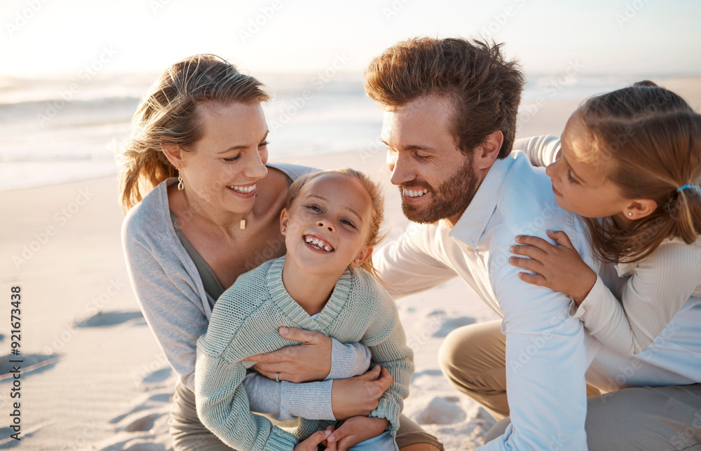 Parents, children and hug at beach, holiday and smile with care, love or bonding on ground in summer. Father, mother and daughter kids for laughing, family or connection in sunshine by ocean in Spain Parents, children and hug at beach, holiday and smile with care, love or bonding on ground in summer. Father, mother and daughter kids for laughing, family or connection in sunshine by ocean in Spain