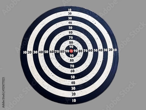 The picture shows a black dart board with a circle of white and black circles from large to small with a red dot in the center and Arabic numerals in each circle. It is used for playing the game.