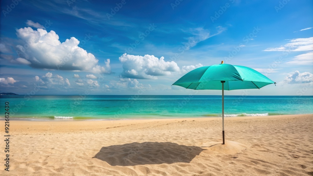Turquoise umbrella providing shade on a sandy beach , beach, tropical, ocean, summer, vacation, relaxation Turquoise umbrella providing shade on a sandy beach , beach, tropical, ocean, summer, vacation, relaxation