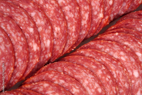 Solid background of sliced smoked sausage.