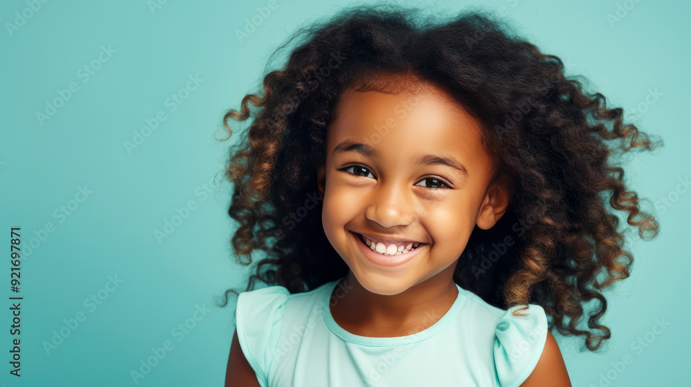 Portrait of smiling cute African American child girl with perfect skin, light blue background, banner. Portrait of smiling cute African American child girl with perfect skin, light blue background, banner.