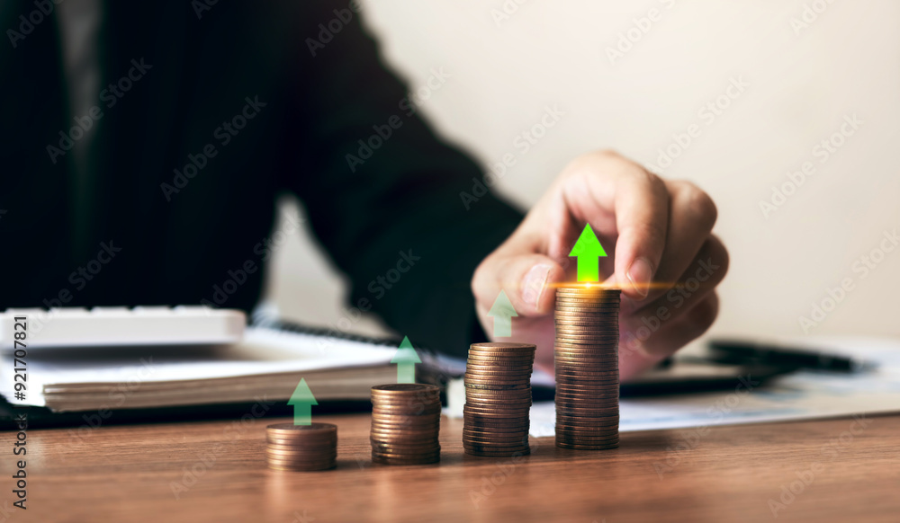 Businessman investors are placing coins in a growing position with savings finance money concept. Businessman investors are placing coins in a growing position with savings finance money concept.