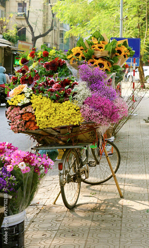 Bicycle carrying flower bouquets for sell around Hanoi during autumn photo