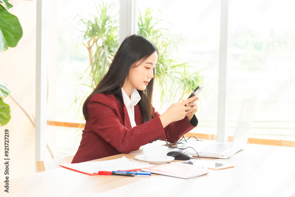 Young thoughtful Asian business woman working in modern office Young thoughtful Asian business woman working in modern office