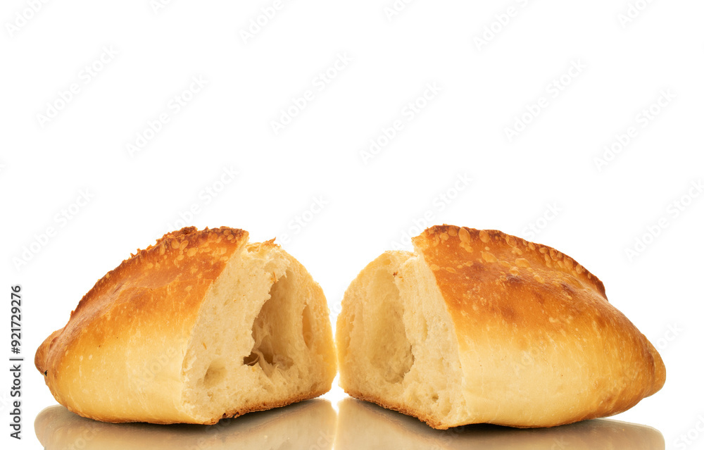 One wheat loaf cut in half, macro, isolated on white background. One wheat loaf cut in half, macro, isolated on white background.