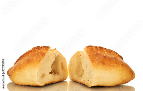 One wheat loaf cut in half, macro, isolated on white background.