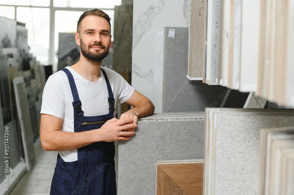 Fototapeta premium Plumber in uniform at showcase in plumbering store