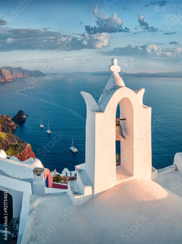 Fototapeta Naklejka Na Ścianę i Meble -  Vertical summer view of Santorini island. Splendid morning scene of famous Greek resort Fira with white bell, Greece, Europe. Traveling concept background.