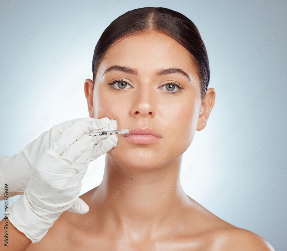 Plastic surgery, portrait or woman in studio for injection, lip filler or facial treatment. Surgeon hands, needle or person on gray background for hyaluronic acid, collagen implant or transformation Plastic surgery, portrait or woman in studio for injection, lip filler or facial treatment. Surgeon hands, needle or person on gray background for hyaluronic acid, collagen implant or transformation