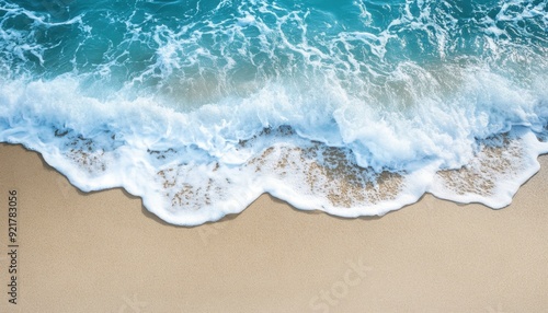 Waves gently breaking on a sandy beach under bright sunlight in a coastal area