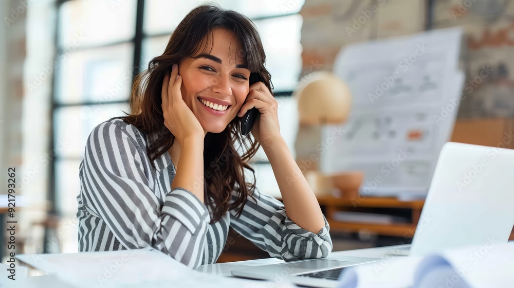 A beautiful professional woman uses a laptop in a modern office A beautiful professional woman uses a laptop in a modern office