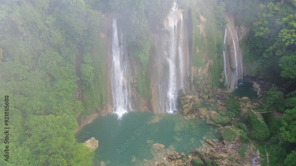 Morning mist at a beautiful rainforest waterfall Morning mist at a beautiful rainforest waterfall
