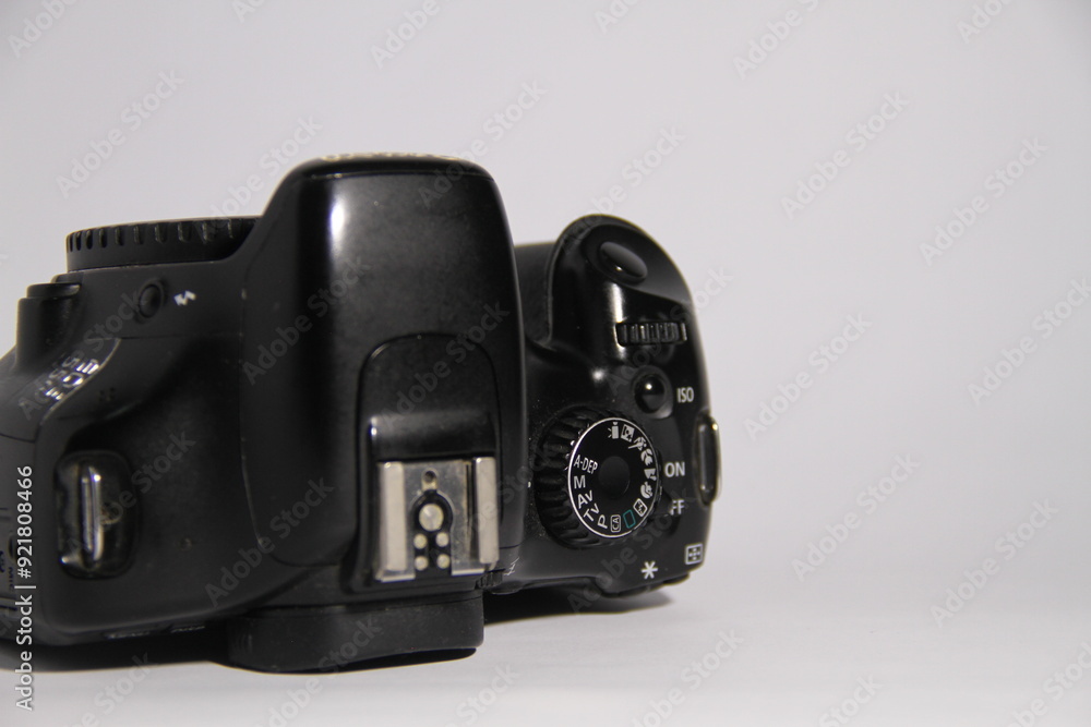 The DSLR camera is black, with a white background. The DSLR camera is black, with a white background.