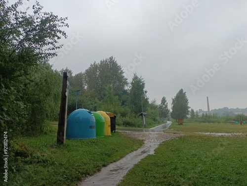 Talsa park during cloudy summer day. Oak and birch tree woodland. Cloudy day with white clouds in sky. Bushes and small are growing in woods. Nature. Talsos parkas. photo