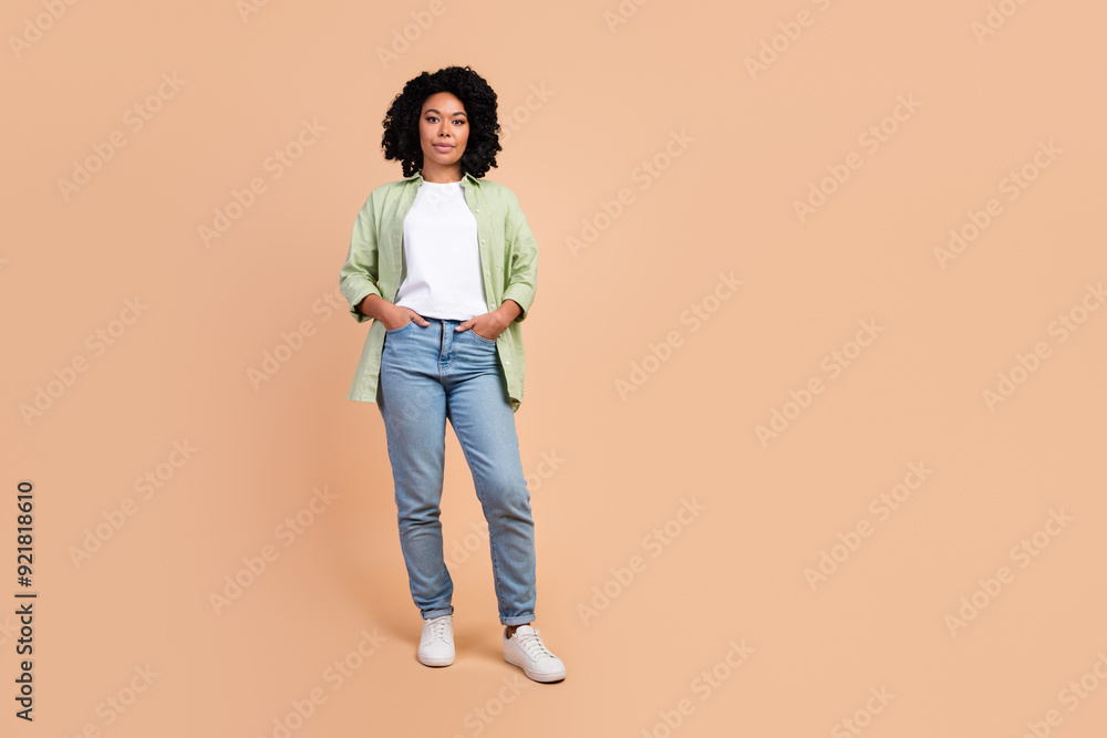 Full length portrait of pretty young woman empty space wear shirt isolated on beige color background Full length portrait of pretty young woman empty space wear shirt isolated on beige color background