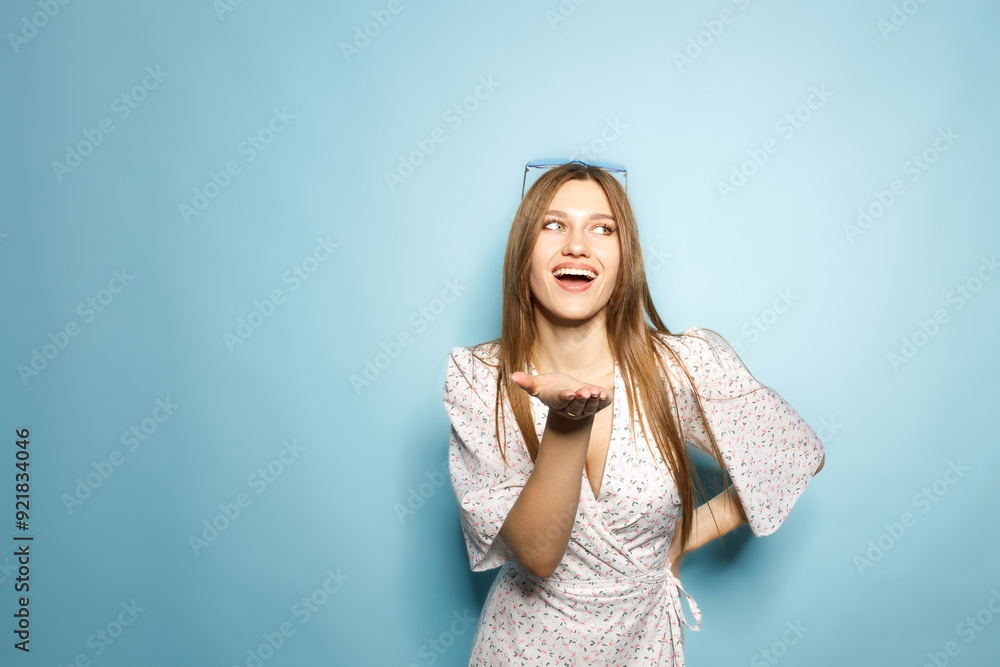 Woman In Summer Dress Posing On Blue Background Woman In Summer Dress Posing On Blue Background