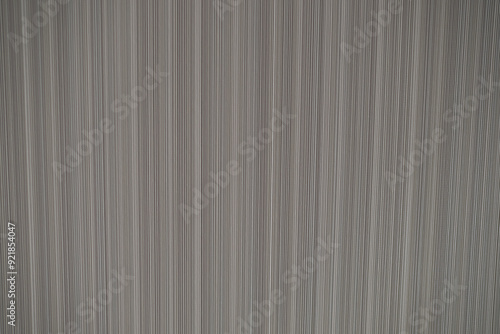 Close-up of vertical striped fabric texture in shades of grey, creating a linear pattern