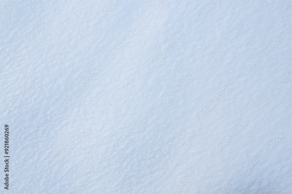 Fototapeta premium Natural snow texture. Smooth surface of clean fresh snow. Snowy ground. Winter background with snow patterns. Perfect for Christmas and New Year design. Closeup top view.