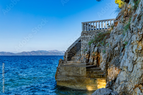 Dangerous descent down steep stairs to a small beach photo