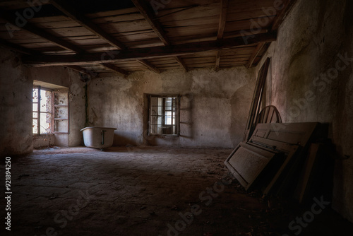 Soft light enters the old abandoned attic, the room is almost empty but the atmosphere is magical 