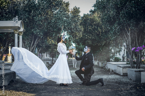 Engaged couple made up as catrines in the cemetery. Day of the dead celebration. photo