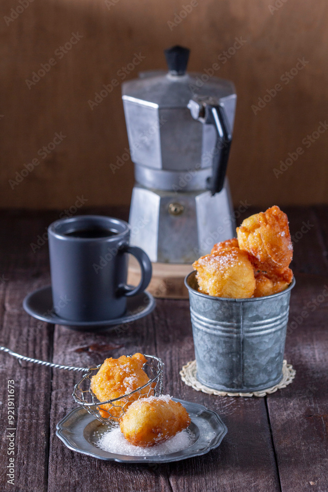 Curd donuts with sugar served with tea or coffee on a light wooden background. Rustic style.