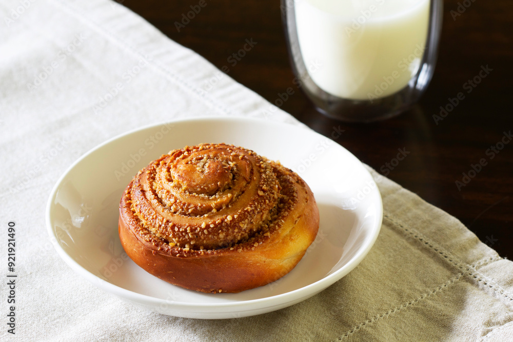 Cinnamon buns with icing served with coffee. Rustic style.