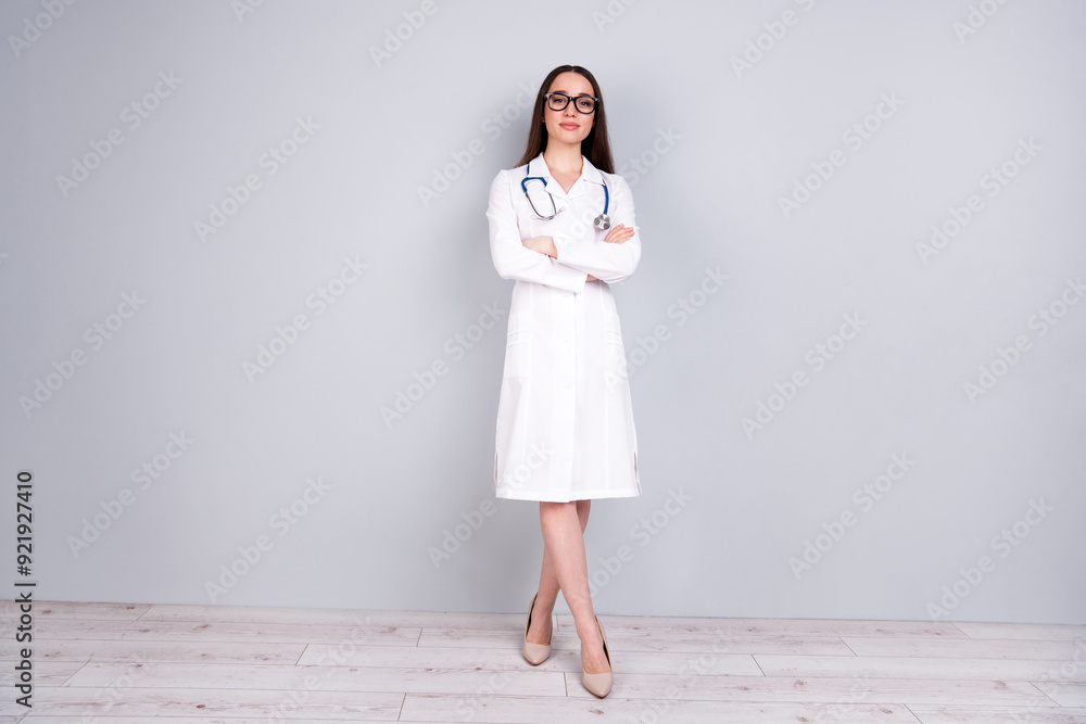 Photo of charming attractive woman intern assistant wear white doctor robe crossed arms isolated on grey color background Photo of charming attractive woman intern assistant wear white doctor robe crossed arms isolated on grey color background
