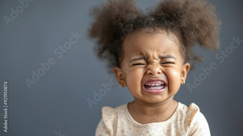 Little sad African American girl crying and screaming with negative facial grimaces, young female frustrated child, unsatisfied kid, unhappy toddler showing sad emotions due to problems, copy space
