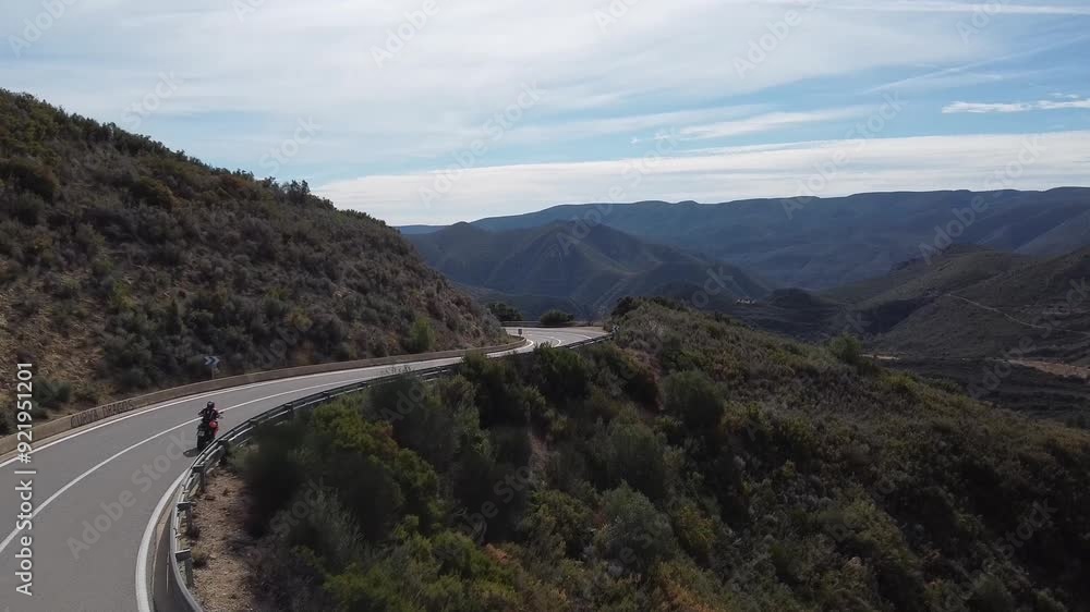 Drone view of a motorcycle in a mountain road Drone view of a motorcycle in a mountain road