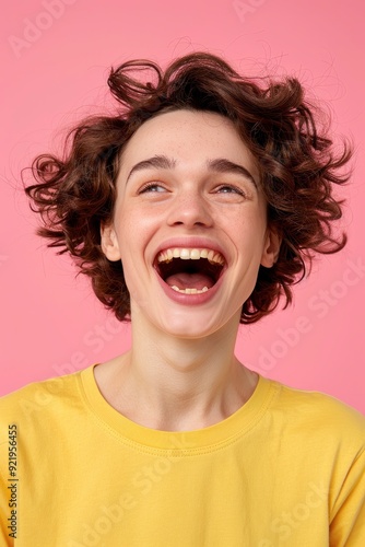 Portrait Of A Beautiful Young Woman Against A Light Pink Background, Happy And Smiling, Shouting With Her Mouth Wide Open