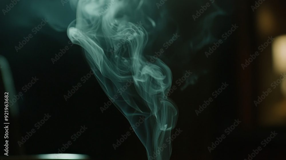 A close-up of smoke drifting from a burning piece of paper in a dark room. The smoke curls and twists in the dim light, creating a mysterious and somewhat eerie effect. A close-up of smoke drifting from a burning piece of paper in a dark room. The smoke curls and twists in the dim light, creating a mysterious and somewhat eerie effect.