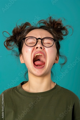 Fed Up And Outraged: A Silly East Asian Troubled Teenager, Screaming And Being Bothered, Shouting Out Loud With Her Mouth Wide Open photo